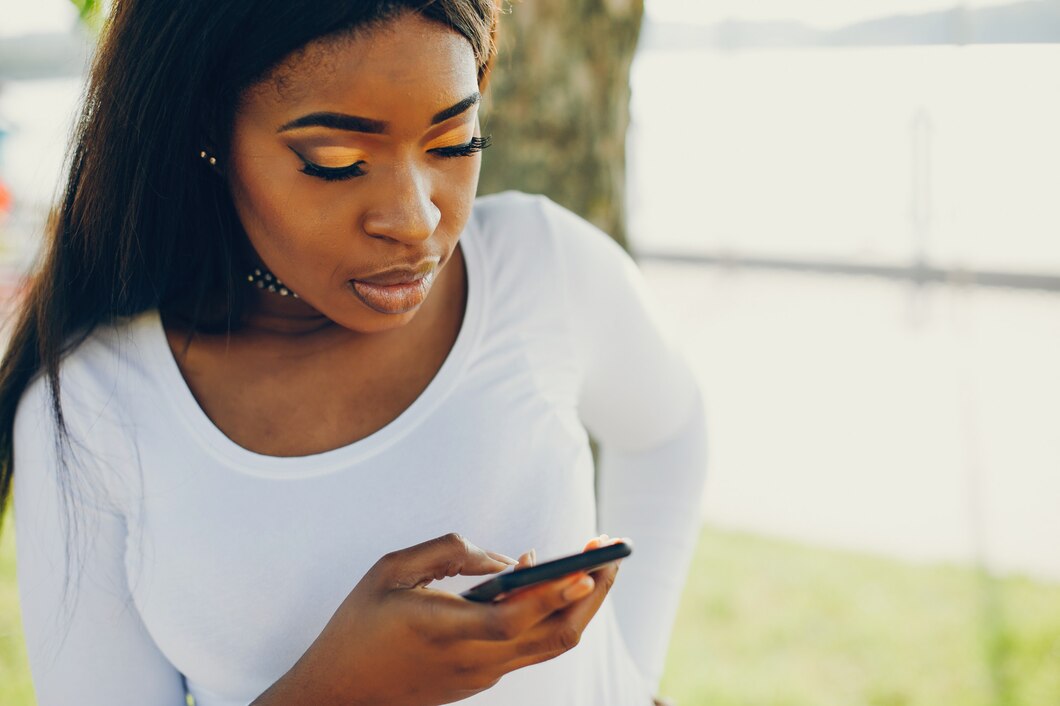 A black lady looking on her phone