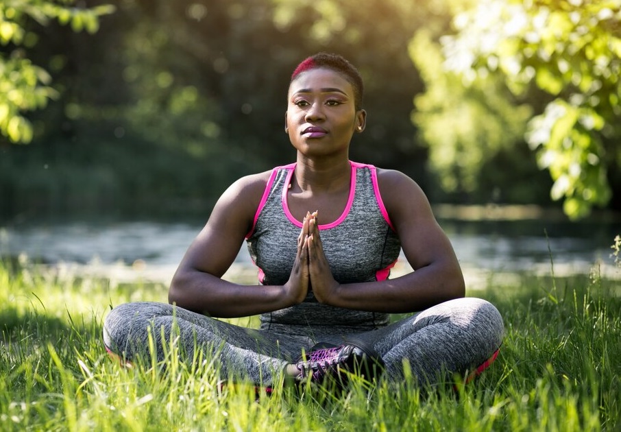 A black woman engaging in mindfulness practice outdoor