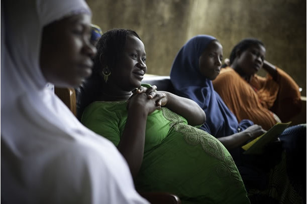 Pregnant African women seated at an antenatal clinic