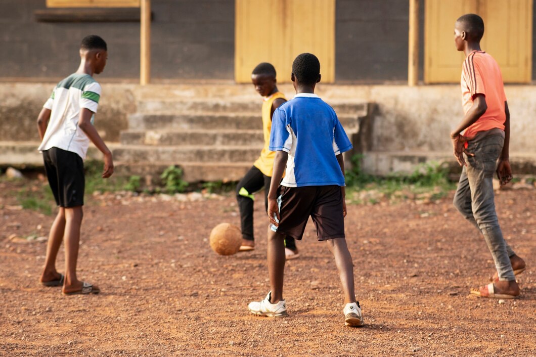 African kids playing football outdoors