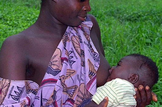 An African mom feeding her baby