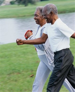 Black elderly couple brisk walking