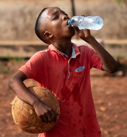 African boy drinking water from a bottle