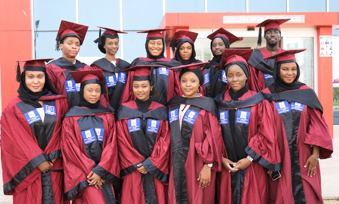 African female university graduates in group photo outdoors