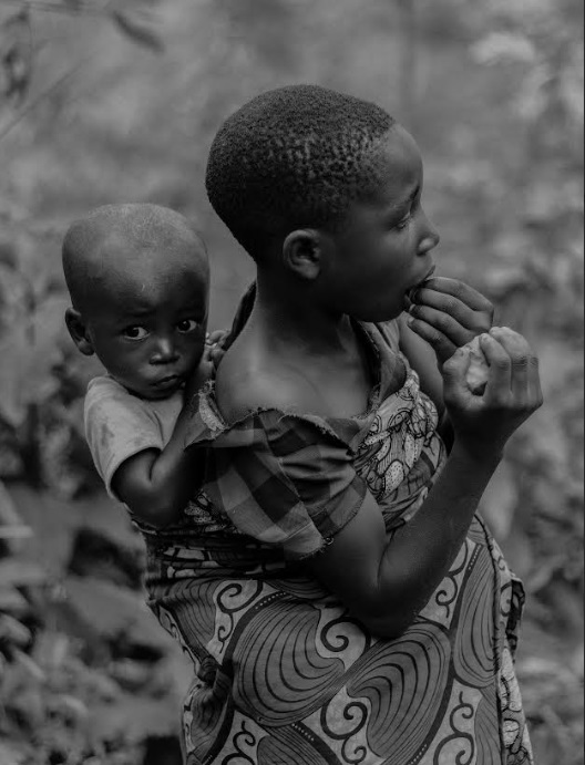 Girl child carrying a babyon her back