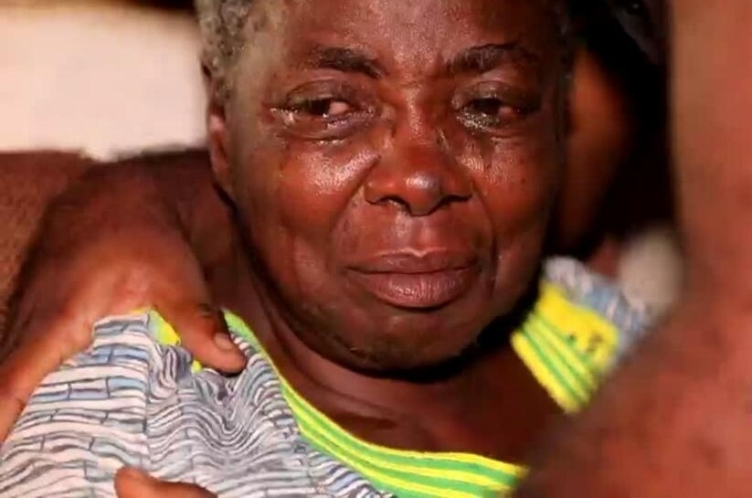 Depressed looking elderly African woman crying