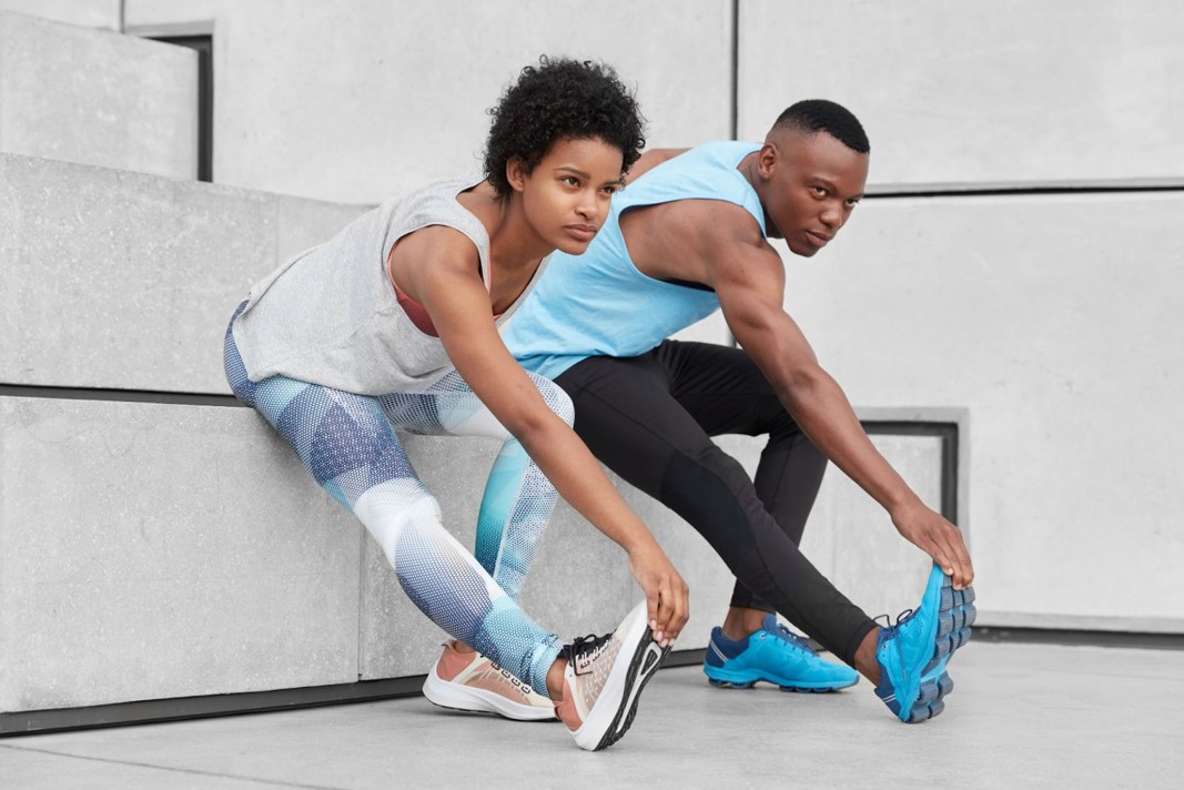 Young black couple doing leg stretch