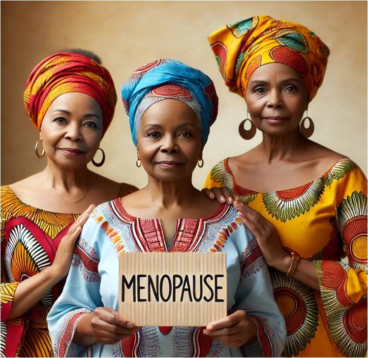 Three African women in clourful attire with one holding menopause sign