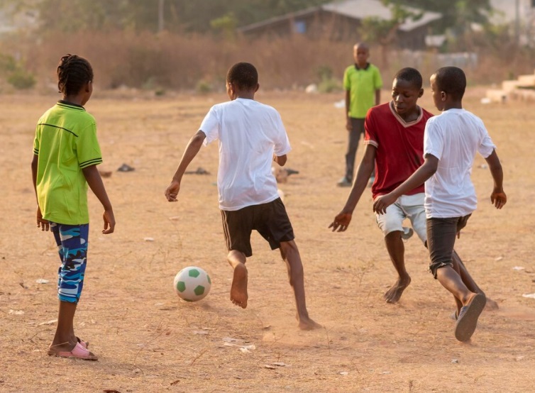 African children playing football outdoors