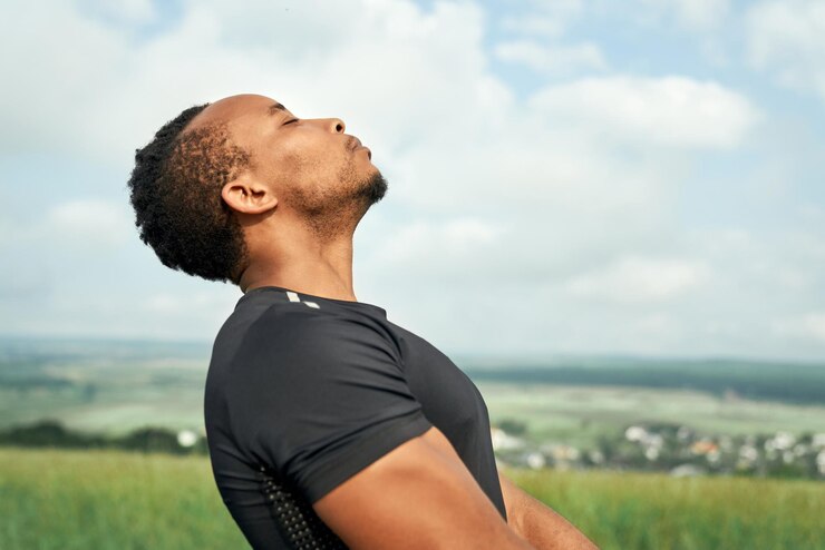 A black male practising deep breathing outdoor