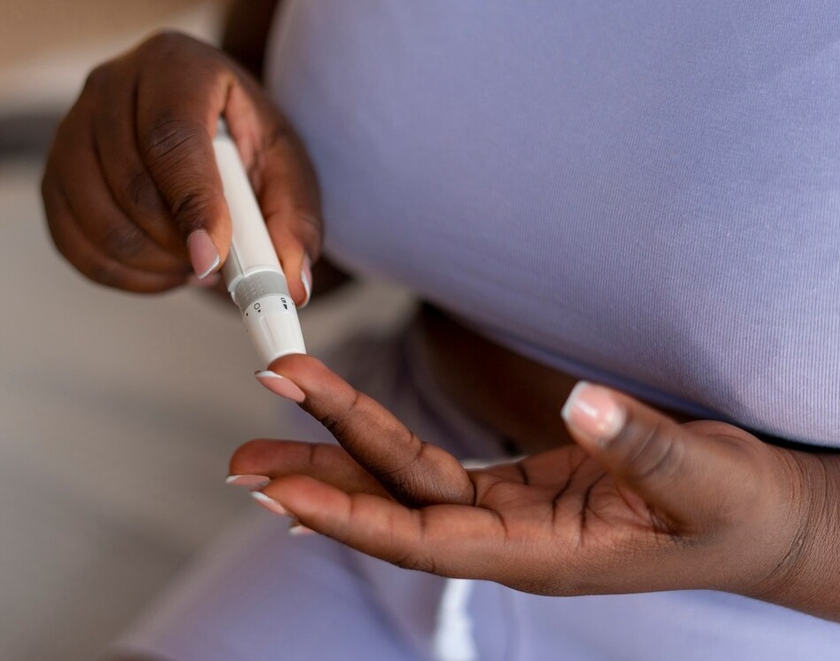 A black lady during a finger prick test for monitoring diabetes