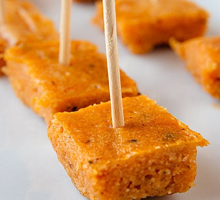 Small cubes of steamed bean pudding on cocktail sticks