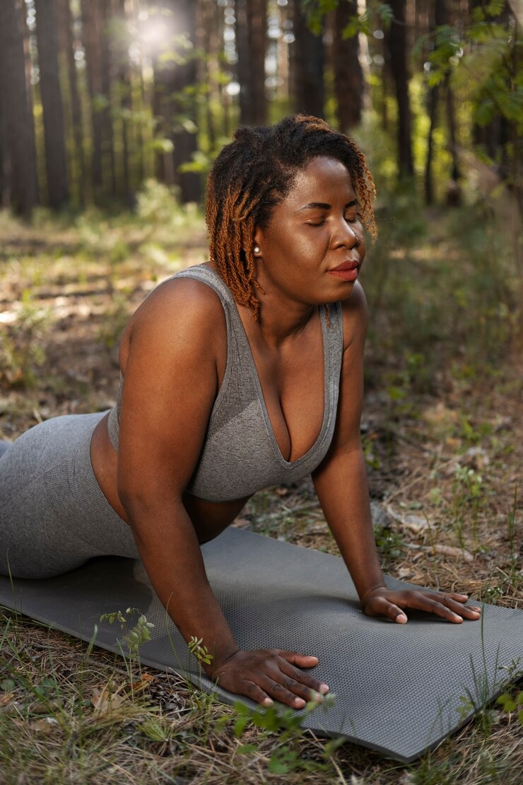 A black lady enjoying yoga in nature