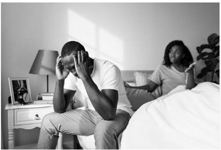 Black couple in bedroom having difficult conversation about infertility