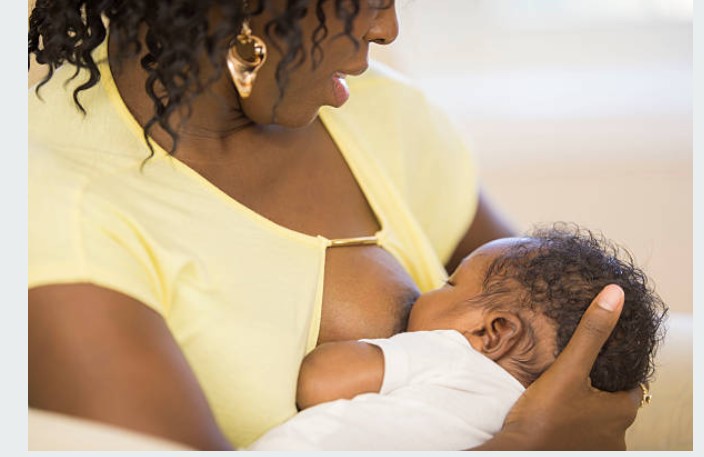 A black mother breastfeeding her baby